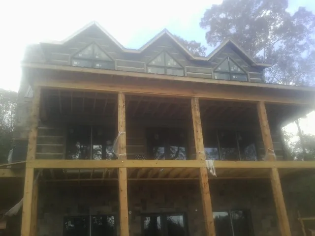 Dormers and porch framing on a large log home under construction in Valley Cottage