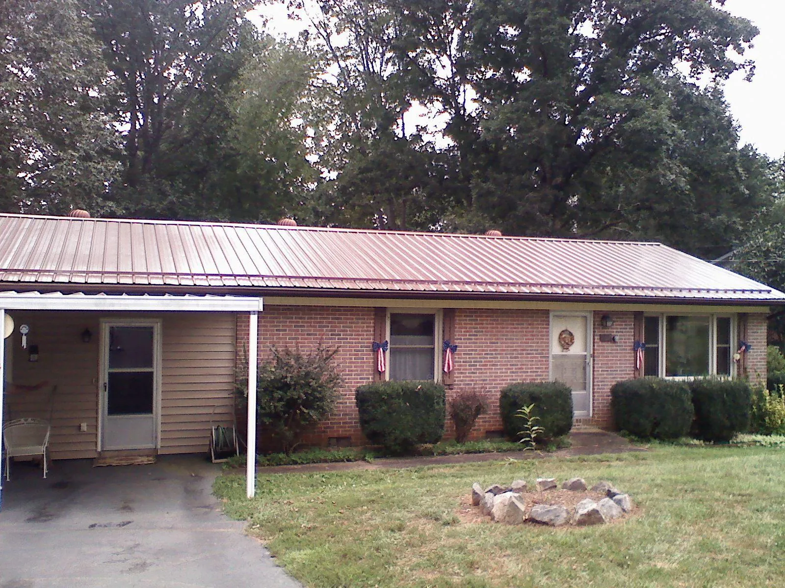 Bronze metal roof and carport on a brick ranch home — Roof Repair work by our crew in Valley Cottage
